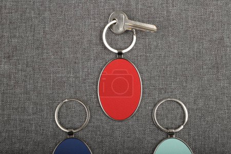Photo for Metal and leather keychains. Colorful one side leather; Square, rectangle and circle shaped key rings. Concept shots, photos taken specially for e-commerce sales. Top view, Close up, Mockup. Free space for text on the leather surface - Royalty Free Image