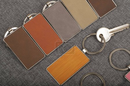 Photo for Metal and leather keychains. Colorful one side leather; Square, rectangle and circle shaped key rings. Concept shots, photos taken specially for e-commerce sales. Top view, Close up, Mockup. Free space for text on the leather surface - Royalty Free Image
