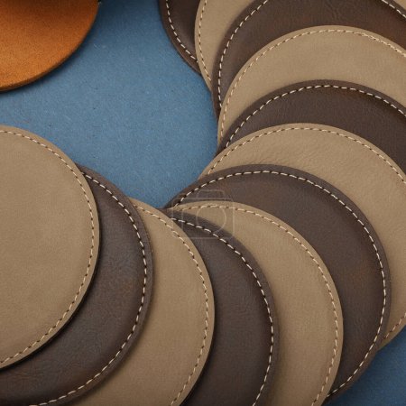 Photo for Leather table mats in different colors. Concept shot, top view. Custom background view of leather table coaster. Stitched and leather table coaster - Royalty Free Image