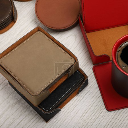 Photo for Leather table mats in different colors. Concept shot, top view. Custom background view of leather table coaster. Stitched and leather table coaster. Beverage coaster. - Royalty Free Image