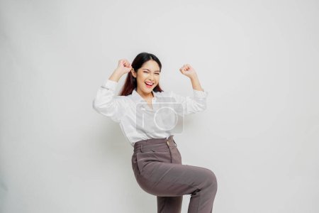 Photo for A young Asian woman with a happy successful expression wearing white shirt isolated by white background - Royalty Free Image