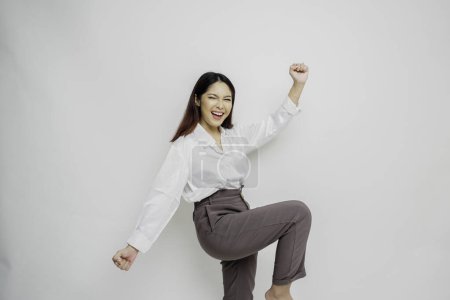 Photo for A young Asian woman with a happy successful expression wearing white shirt isolated by white background - Royalty Free Image