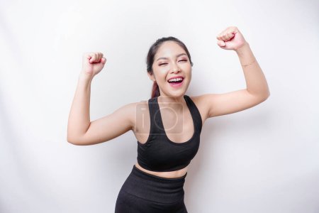 Photo for A young sporty Asian woman with a happy successful expression wearing sportswear isolated by white background - Royalty Free Image