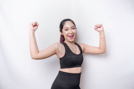 Photo for A young sporty Asian woman with a happy successful expression wearing sportswear isolated by white background - Royalty Free Image
