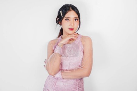 Portrait of a young beautiful Asian woman wearing a pink dress, beauty shoot concept