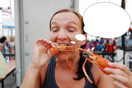 Funny picture with bubble idea woman eats shrimp.