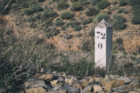 Boundary stone marks on old railway line in Andalusia, Spain.