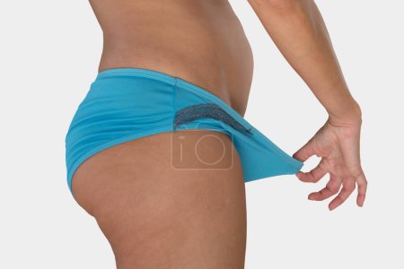 Foto de Overweight diet progress, close-up ass and abdomen woman on white background. - Imagen libre de derechos