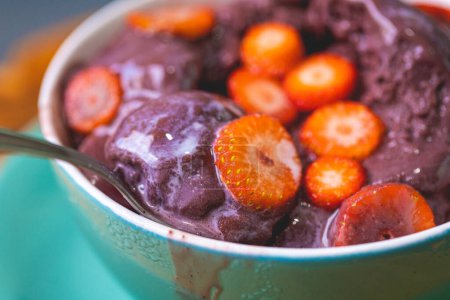 Photo for Acai with strawberry and condensed milk in a bowl. Brazilian food, dessert. - Royalty Free Image