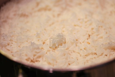 Photo for Water boiling for cooking rice over a dark stove. - Royalty Free Image