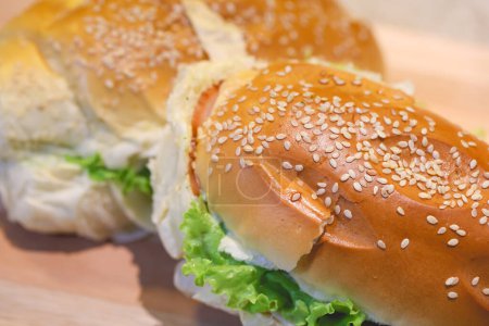 Photo for Bread sandwiches with sesame seeds, turkey breast, mozzarella cheese, lettuce, tomatoes and seasoned mayonnaise - Royalty Free Image
