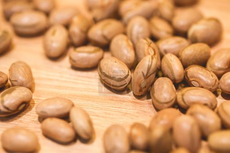 Photo for Raw pinto beans on a wooden board. Close-up photo. - Royalty Free Image