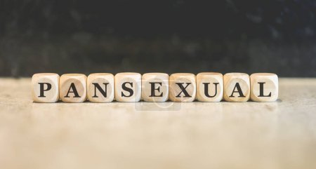 Photo for Inscription Pansexual written on wooden cubes. Black background. - Royalty Free Image