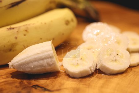 Photo for Close-up view of fresh sliced bananas on wooden board - Royalty Free Image