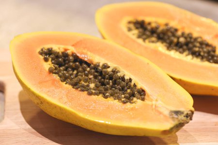Photo for Close-up view of sliced papaya on wooden board - Royalty Free Image