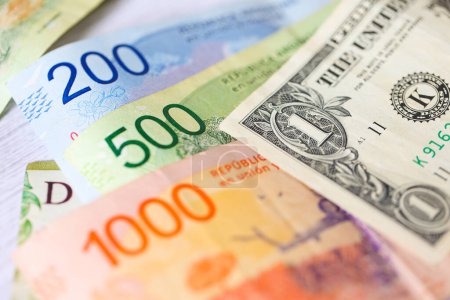 Argentine peso bills and United States dollar bills. Economy and finance.