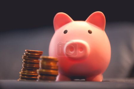 Photo for Close-up view of pink piggy bank and coins. Finance concept. - Royalty Free Image