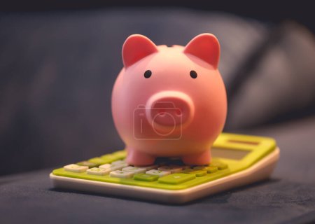 Photo for Close-up view of piggy bank and calculator. Finance and economy concept. - Royalty Free Image