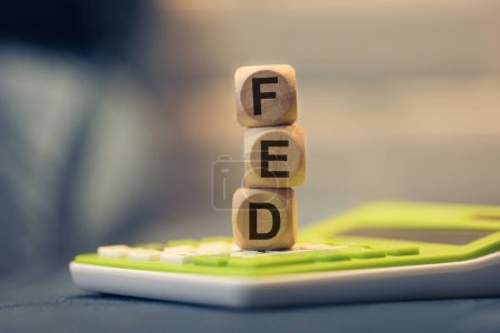 Photo for The acronym FED written on wooden cubes. A calculator in the composition. - Royalty Free Image