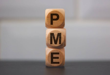 Téléchargez les photos : L'acronyme PME for Small and Medium Enterprise en portugais brésilien écrit sur des cubes de bois sur fond gris - en image libre de droit