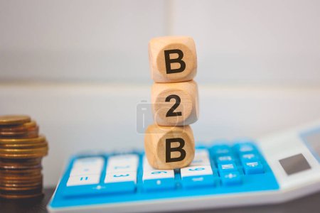 Photo for The acronym B2B written on wooden cubes. A calculator in the composition. - Royalty Free Image