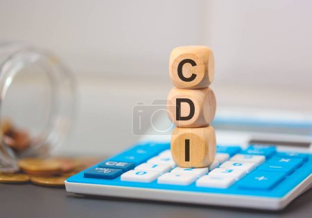 Photo for The acronym CDI written on wooden cubes. A calculator in the composition. - Royalty Free Image