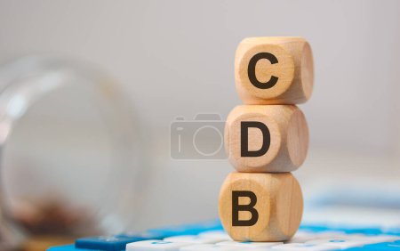 Photo for The acronym CDB written on wooden cubes. A calculator in the composition. - Royalty Free Image