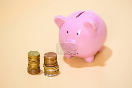 Photo for Close-up view of pink piggy bank and coins. Finance concept. - Royalty Free Image