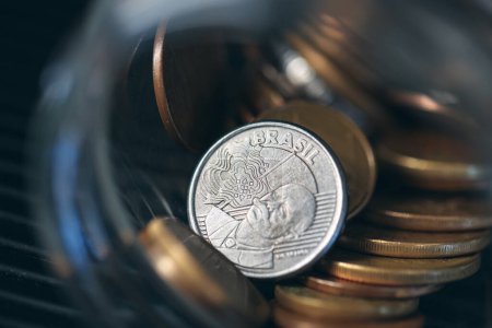 Photo for Money from Brazil. Brazilian coins inside a glass jar. Brazilian economy. Macro photography. - Royalty Free Image