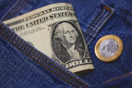 Photo for Real coin and United States dollar bills in a jeans pocket in macro photo. - Royalty Free Image