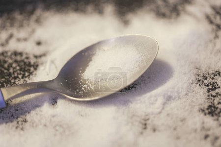 Photo for Close-up view of teaspoon of sugar on the table - Royalty Free Image