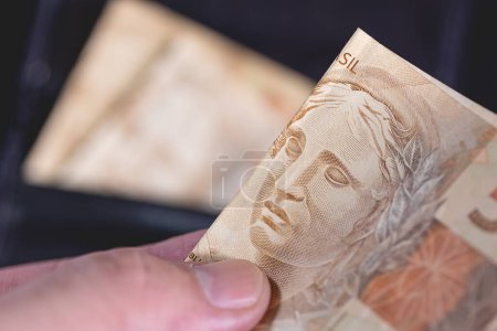 Photo for Close-up view of Brazilian Real Banknote. Brazilian economy, finance and income tax. - Royalty Free Image