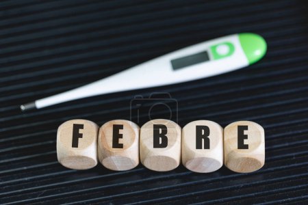 Photo for Text febre written on wooden dice in Brazilian Portuguese language. Disease, sickness - Royalty Free Image