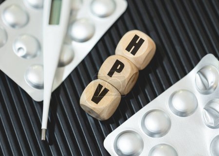 Photo for The abbreviation HPV for human papillomavirus written on wooden dice. Health, Medicine, Sick, Patient - Royalty Free Image