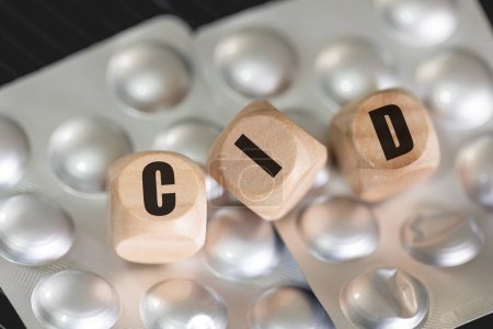 Photo for The abbreviation ICD for International Classification of Diseases written on wooden dice in the Brazilian Portuguese language. Health, Medicine, Sick, Patient - Royalty Free Image