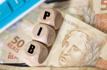 The acronym PIB for gross domestic product in Brazilian Portuguese written on wooden dice. 