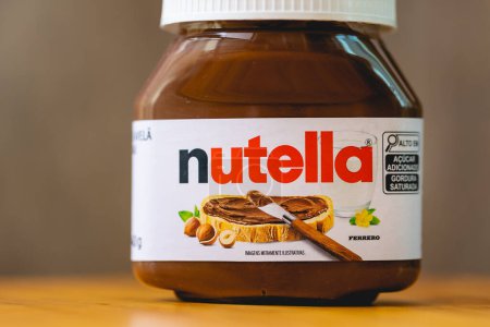 Photo for Small jar of Nutella on a wooden board. Hazelnut cream with cocoa. Sweet food. Brazil, 03/01/2024 - Royalty Free Image