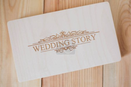 Photo for Wooden photo box for photo storage on wooden background. Box with flash with laser engraving "wedding story" set for the photographer, presentable set of photos, luxury feedback to client. - Royalty Free Image