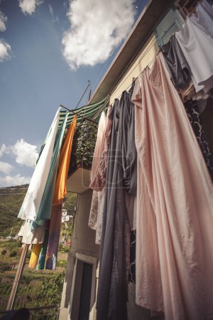 Clothes on the rope between windows, European town, Italy. The linen dries on a rope in the street after washing. Typical situation for Italy. 