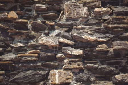 Photo for Stone wall. Outdoor background natural stone. texture Stone wall of an ancient village. part of a stone wall, for background or texture. - Royalty Free Image
