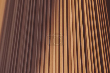 Fondo de patrón de cortinas de material textil de color claro cálido. pantalla de lámpara cónica. sombra en la pantalla estilo vintage, fondo abstracto. 