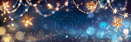 Photo for String Star Lights In Blue Defocused Abstract Background With Glittering And Bokeh - Royalty Free Image