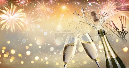  Toast du Nouvel An avec Champagne et feux d'artifice - Fête de célébration avec horloge visage avec des lumières abstraites déconcentrées
