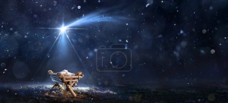 Téléchargez les photos : Scène de la Nativité - Naissance de Jésus-Christ avec la Manger dans la nuit enneigée et le ciel étoilé - Résumé fond déconcentré - en image libre de droit