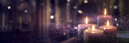 Photo for Advent Candles Burning In The Dark With Glitter On Flames And Abstract Defocused Lights - Royalty Free Image