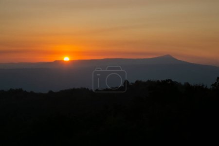 Photo for The morning of sunshine behind the Khao Yai national park mountain  in the  winter of Thailand. Asia sunrise view - Royalty Free Image