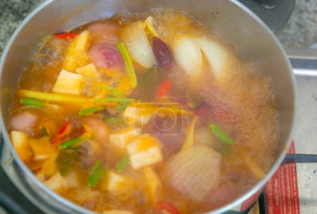 Photo for Tom Yum soup is boiling in the pot. Thailand favorite food. sour and spicy soup local food of Thailand - Royalty Free Image