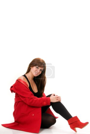 Photo for Attractive woman in red coat on white background - Royalty Free Image