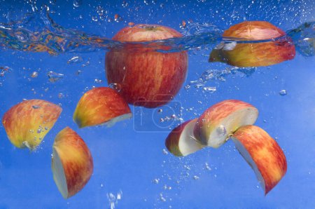 Photo for Apple under water with a trail of transparent bubbles - Royalty Free Image