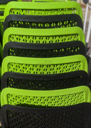 Photo for Pilled terrace plastic stools. Black and green color - Royalty Free Image